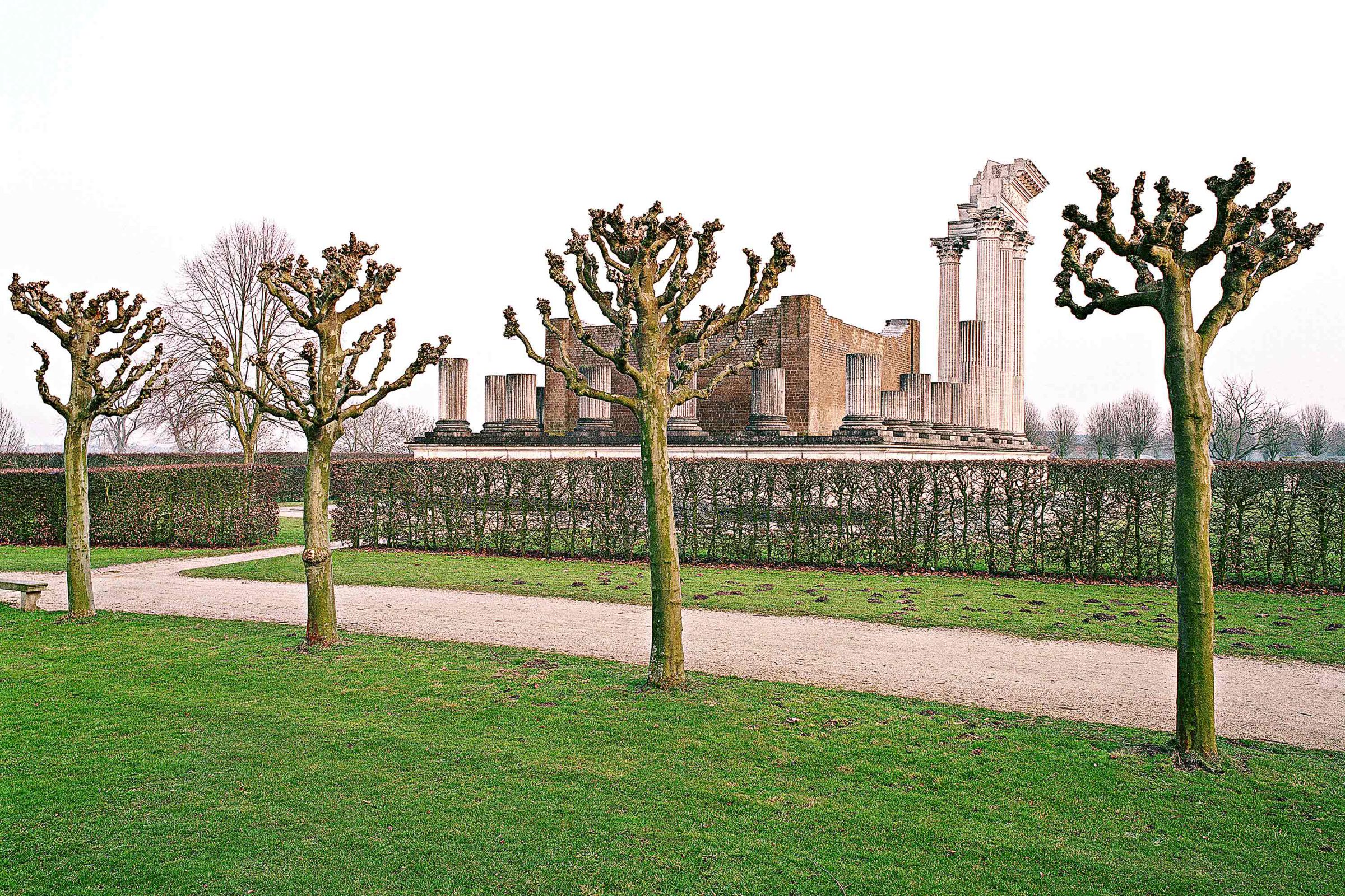Reconstructed Roman harbour temple behind pollarded trees, Xanten Archaeological Park